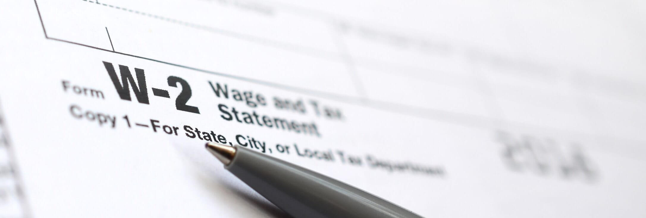the-pen-lies-on-the-tax-form-w-2-wage-and-tax-stat-2021-08-30-05-54-21-utc-scaled-e1643233092315